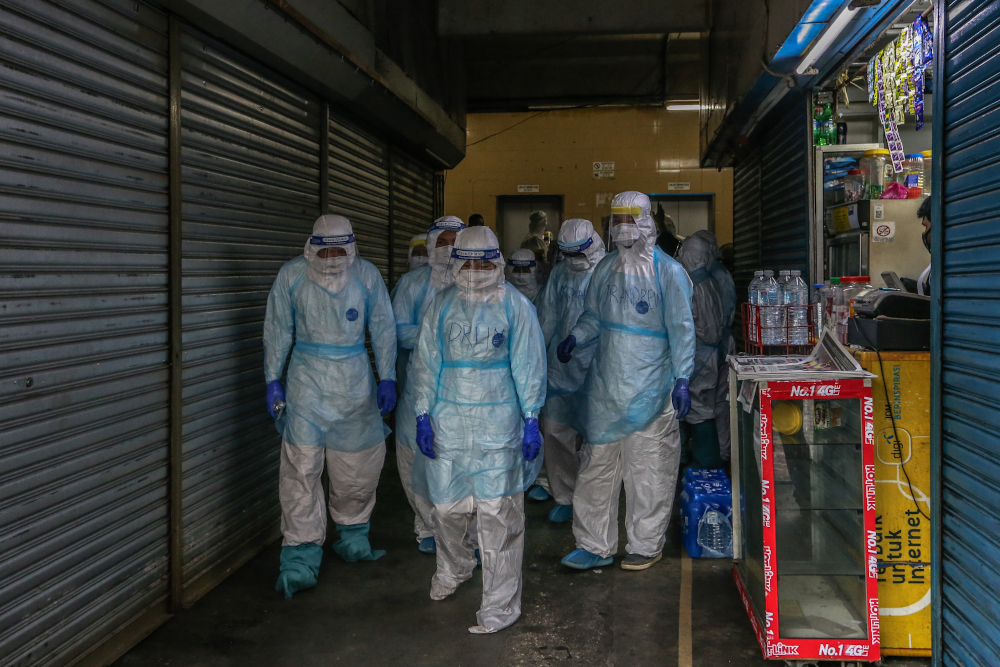 Health workers in protective suits are seen at Selangor Mansion in Jalan Masjid India April 6, 2020. u00e2u20acu201dPicture by Firdaus Latif
