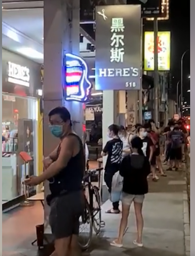 Singaporeans queuing up in front of a salon in Geylang Road to get their haircuts. u00e2u20acu201d Screenshot courtesy of Facebook/David Gan