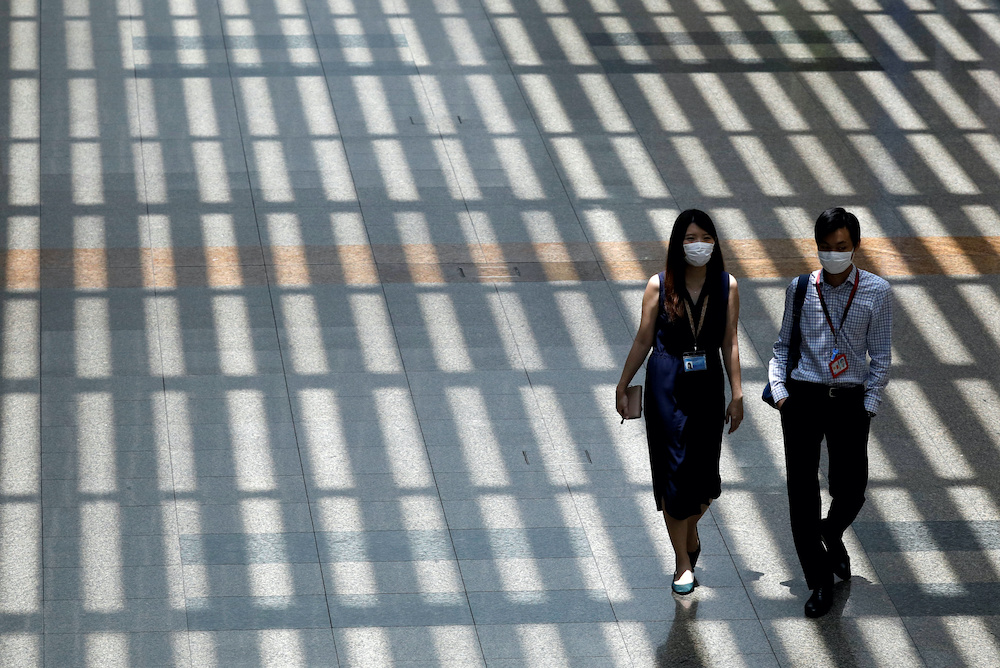 People wearing protective face masks walk a Singaporeu00e2u20acu2122s Changi Airport, following the outbreak of the coronavirus disease (Covid-19) March 30, 2020. u00e2u20acu201d Reuters pic