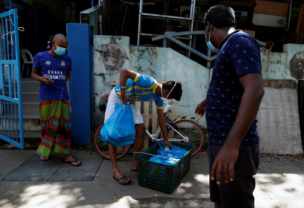 Food delivered by non-governmental organization Alliance of Guest Workers Outreach are left at the entrance of a factory-converted dormitory for workers to collect during the coronavirus disease outbreak in Singapore April 22, 2020. — Reuters pic