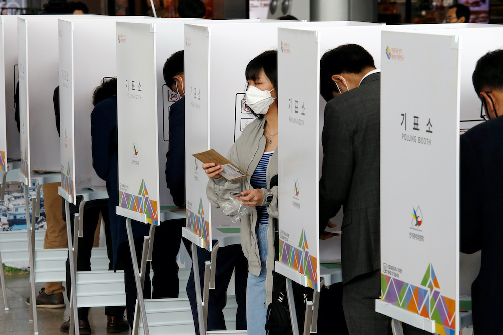 A woman wearing a mask to prevent contracting the coronavirus leaves a voting booth to cast her absentee ballot for the parliamentary election at a polling station in Seoul, South Korea, April 10, 2020. u00e2u20acu201d Reuters picnn