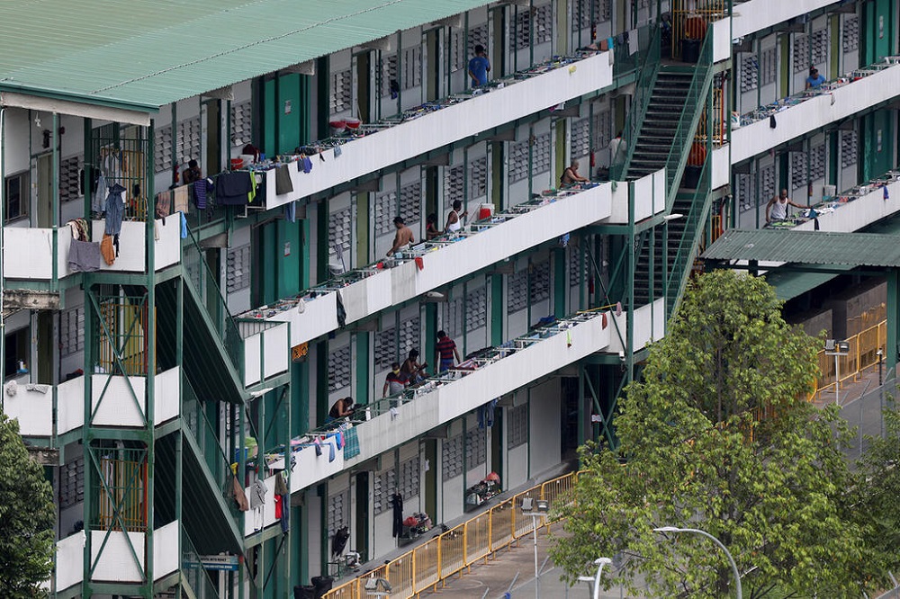 Workers at Cochrane Lodge ll dormitory in Sembawang on April 15, 2020. The dormitory has 46 confirmed cases of Covid-19 and has been gazetted as an isolation area. u00e2u20acu2022 Picture by Nuria Ling/TODAY