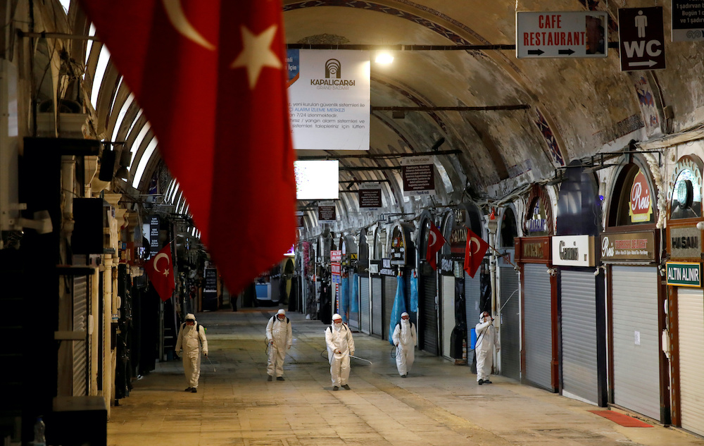 Workers in protective suits spray disinfectant at Grand Bazaar, known as the Covered Bazaar, to prevent the spread of coronavirus disease (Covid-19), in Istanbul, Turkey, March 25, 2020. u00e2u20acu201d Reuters picnnn