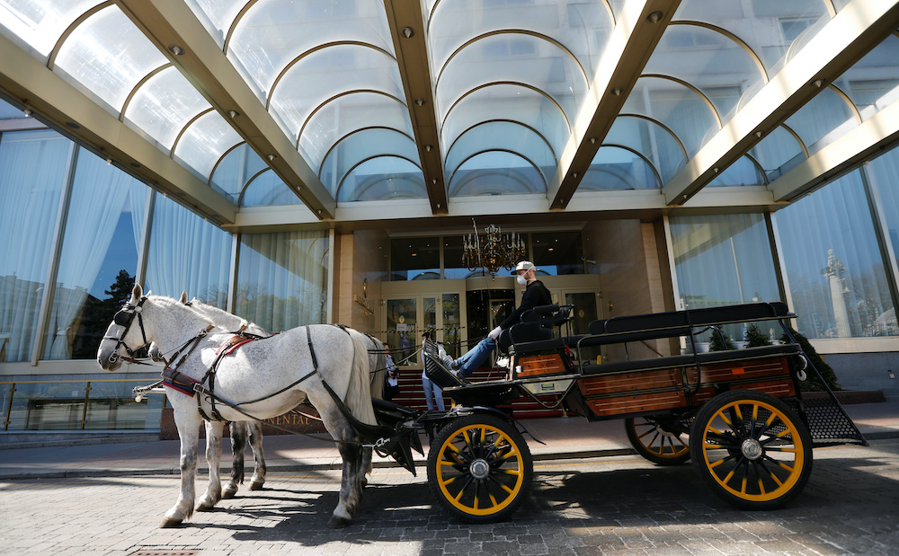 A Fiaker horse carriage waits for food packages for delivery in front of the InterContinental Hotel during the coronavirus disease (Covid-19) outbreak in Vienna, Austria April 8, 2020. u00e2u20acu201d Reuters picnn