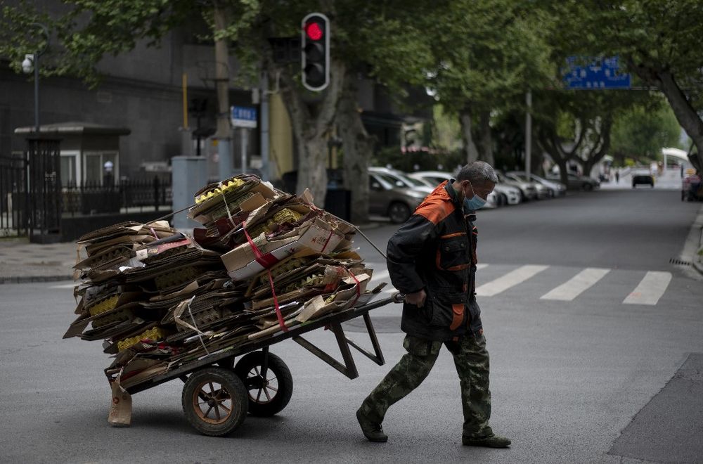 A man pulls a cart loaded with cardboard along a street in Wuhan in Chinau00e2u20acu2122s central Hubei province on April 14, 2020. u00e2u20acu201d AFP pic
