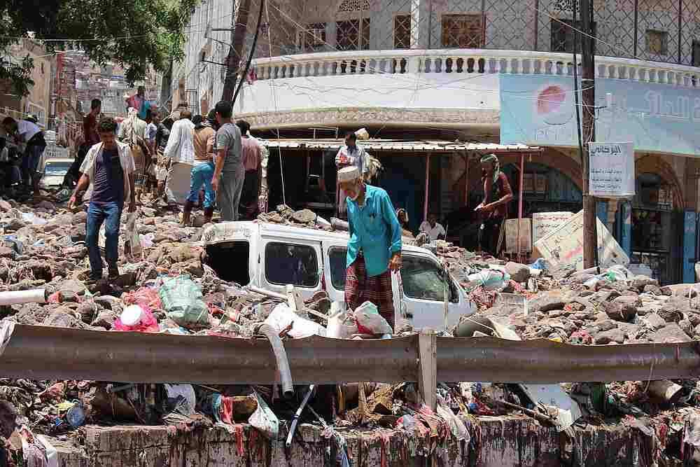 People inspect damage caused by floods on a street in Aden, Yemen April 22, 2020. u00e2u20acu201d Reuters pic