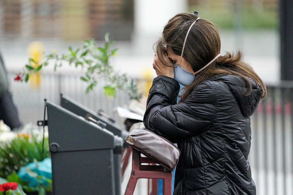 Adriana Gomez prays outside the Our Lady Queen of Angels Catholic Church on Palm Sunday during the Covid-19 outbreak in Los Angeles, California April 5, 2020. u00e2u20acu201d Reuters pic