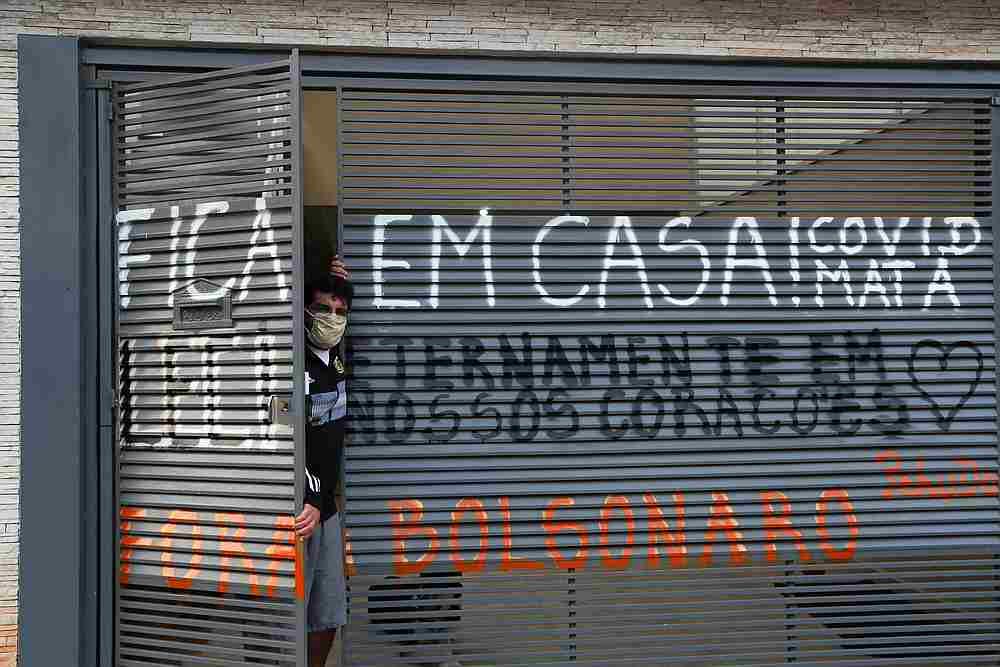 Marcio Rodrigues Alves, 41, next to the gate of his house where he wrote a message as a tribute to and protest against his motheru00e2u20acu2122s death of Covid-19 in Sao Paulo, Brazil, April 23, 2020. u00e2u20acu201d Reuters pic