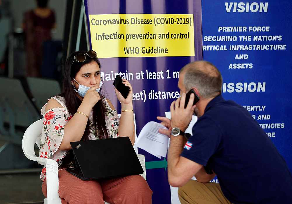 A British citizen, stranded in Gujarat state following the Covid-19 outbreak, speaks with an official at the Sardar Vallabhbhai Patel International (SVPI) airport in Ahmedabad, India April 13, 2020. u00e2u20acu201d Reuters pic