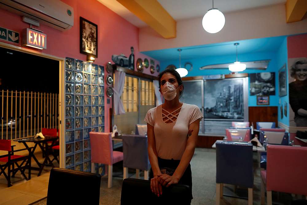 A waitress watches the TV as she waits for costumers in a restaurant, following the outbreak of the Covid-19, in Buenos Aires, Argentina March 18, 2020. u00e2u20acu201d Reuters pic