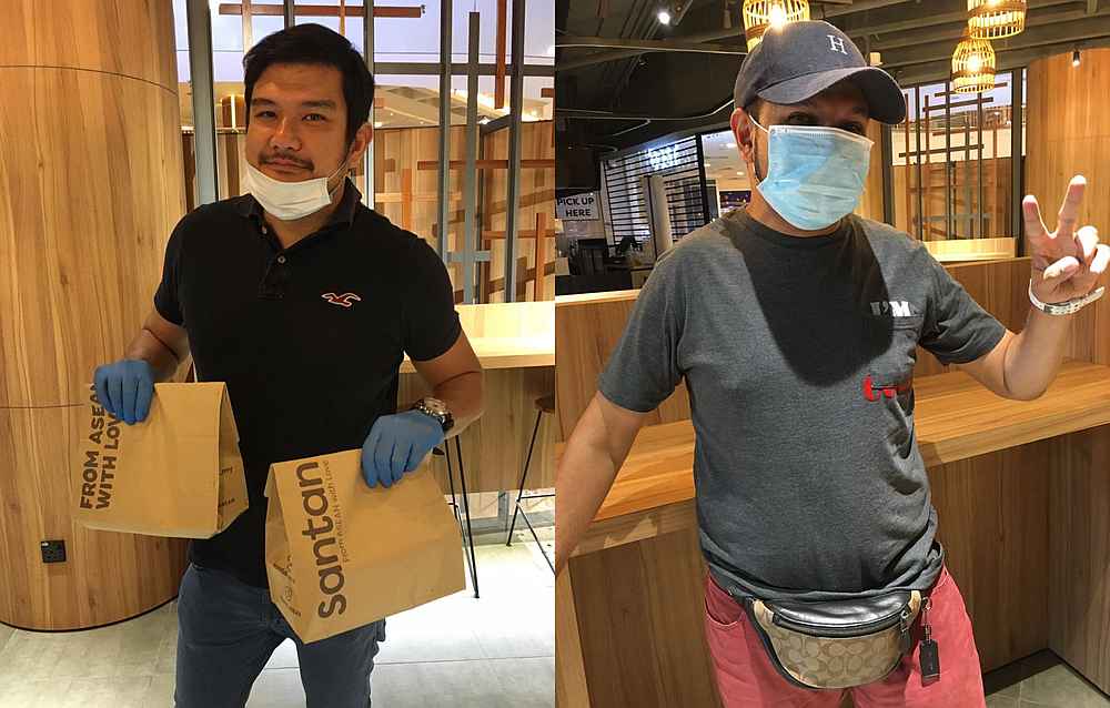 Benyamin Ismail (left) says he would gladly do food delivery again to show support to his fellow AirAsia X colleagues like Felix Junior Theseira (right). u00e2u20acu201d Picture courtesy of AirAsia
