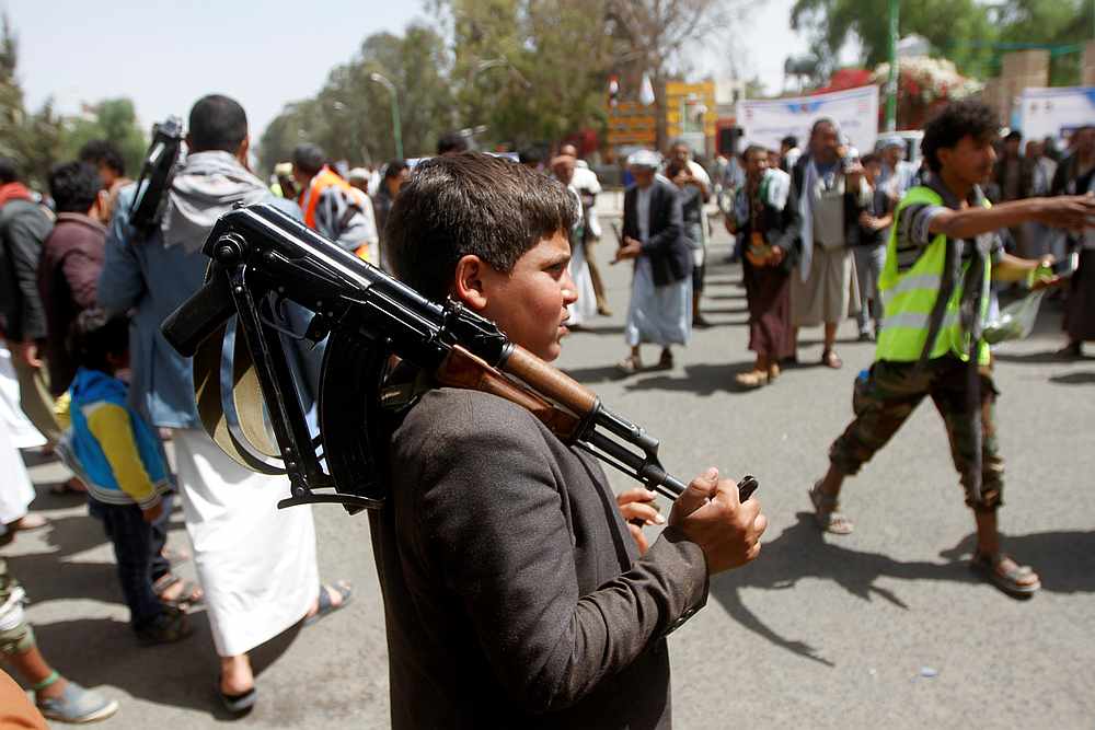 A boy carries a weapon as he and Houthi supporters are seen during a gathering in Sanaa, Yemen April 2, 2020. — Reuters pic