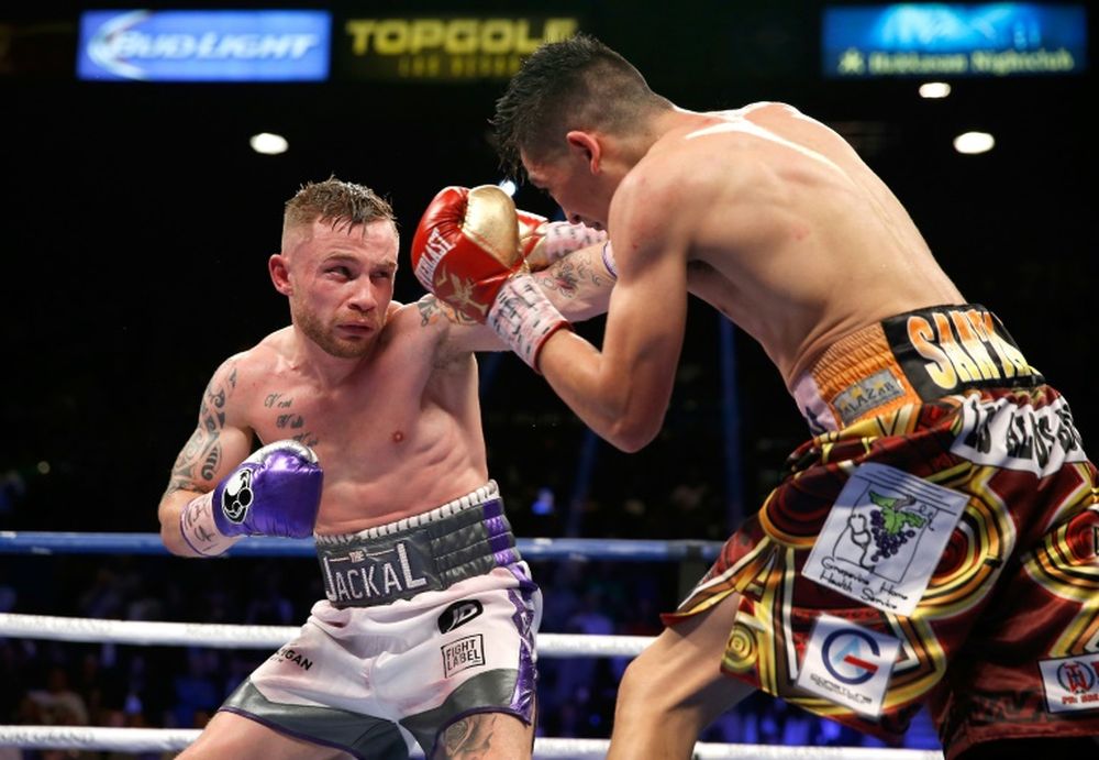 In this file photo taken on January 28, 2017 Northern Ireland's Carl Frampton (left) throws a left punch at USAu00e2u20acu2122s Leo Santa Cruz during their WBC Super Featherweight title fight at the MGM Grand Arena in Las Vegas. u00e2u20acu201d AFP pic