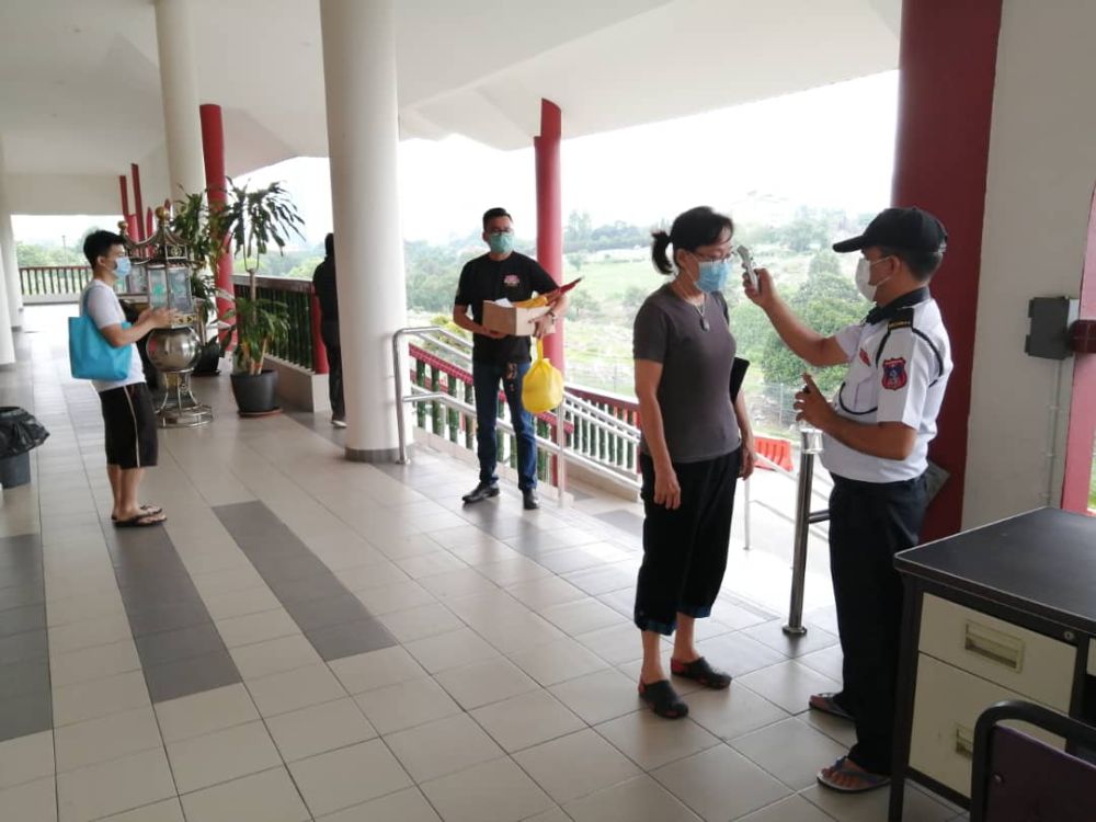 Temperature checks are mandatory for all visitors who attend funeral ceremonies at The Kuala Lumpur Hokkien Cemetery. ― Picture courtesy of Tan Peng Chung