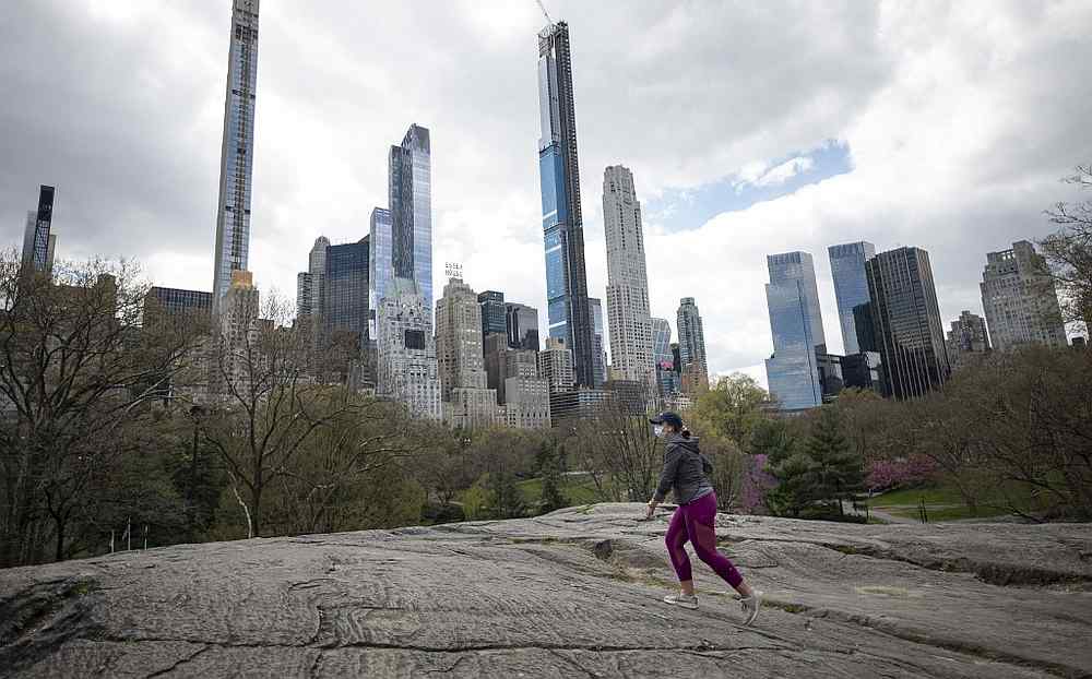 A woman wearing a mask walks in the almost deserted Central Park in New York April 16, 2020.  u00e2u20acu201d AFP pic