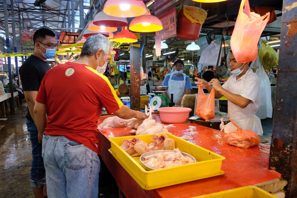 People shop for essential food items at the Chow Kit wet market in Kuala Lumpur April 24, 2020. — Picture by Yusof Mat Isa