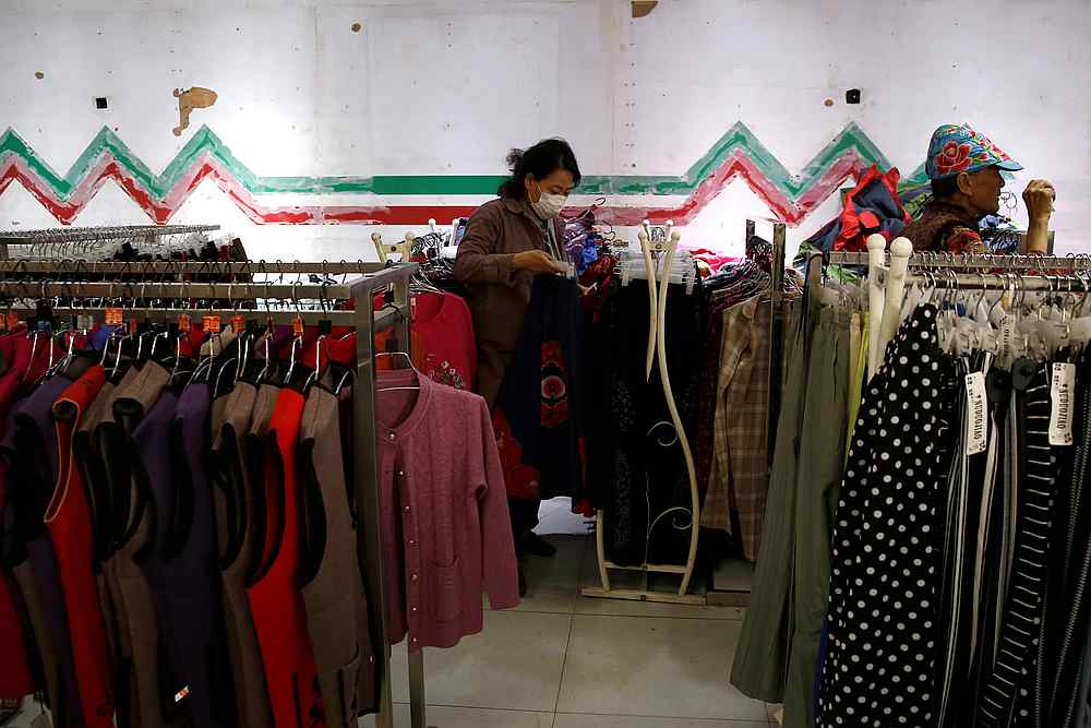 A woman wearing a face mask shops at a clothing store in Beijing, China April 17, 2020.u00e2u20acu201d Reuters pic 