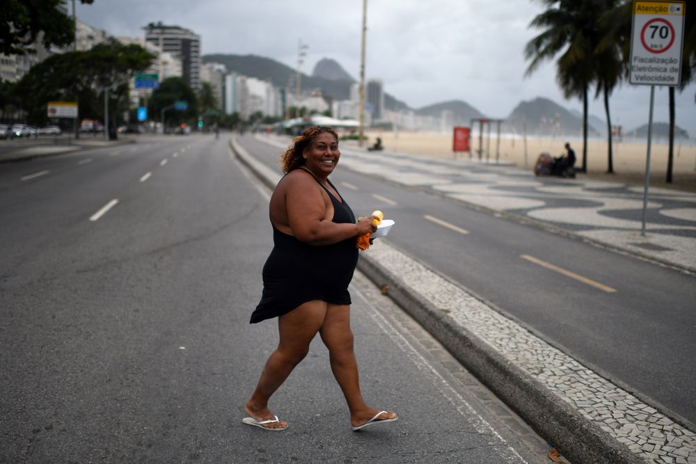 A homeless person carries food from a group of residents of the Chapeu Mangueira slum, during the coronavirus disease (Covid-19) outbreak, near Copacabana beach in Rio de Janeiro, Brazil, April 11, 2020. u00e2u20acu201d Reuters pic