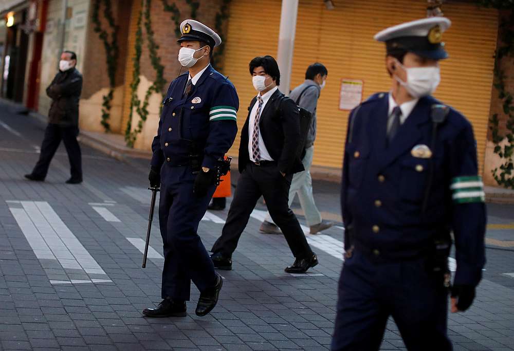 Police officers wearing protective face masks patrol on the street, after the government announced the state of emergency, in Tokyo, Japan April 14, 2020. u00e2u20acu201d Reuters pic