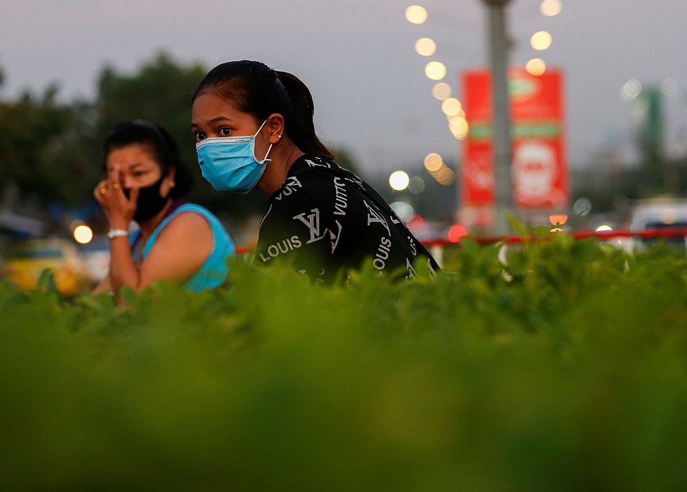 Women wearing protective face masks look out for traffic before crossing a road during the Covid-19 outbreak, at Talad Thai wholesale market outside Bangkok, Thailand April 20, 2020. u00e2u20acu201d Reuters pic