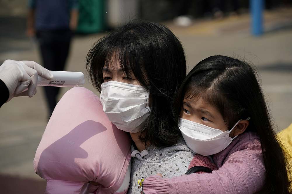 A voter gets her temperature taken at a polling station during the parliamentary election, amid the Covid-19 pandemic, in Seoul, South Korea April 15, 2020. u00e2u20acu201d Reuters pic
