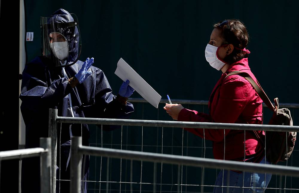 A medical worker gathers information from a woman who wants to get tested for Covid-19 as part of a study on undetected infections in Prague, Czech Republic April 23, 2020. u00e2u20acu201d Reuters pic