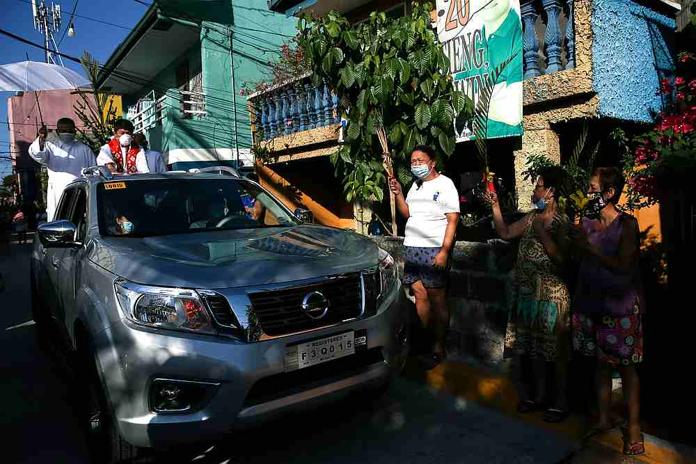 Filipino Catholics wave palm fronds outside their homes to be blessed by a priest roaming neighbourhoods to celebrate Palm Sunday amid lockdown in Manila, Philippines, April 5, 2020. u00e2u20acu201d Reuters pic
