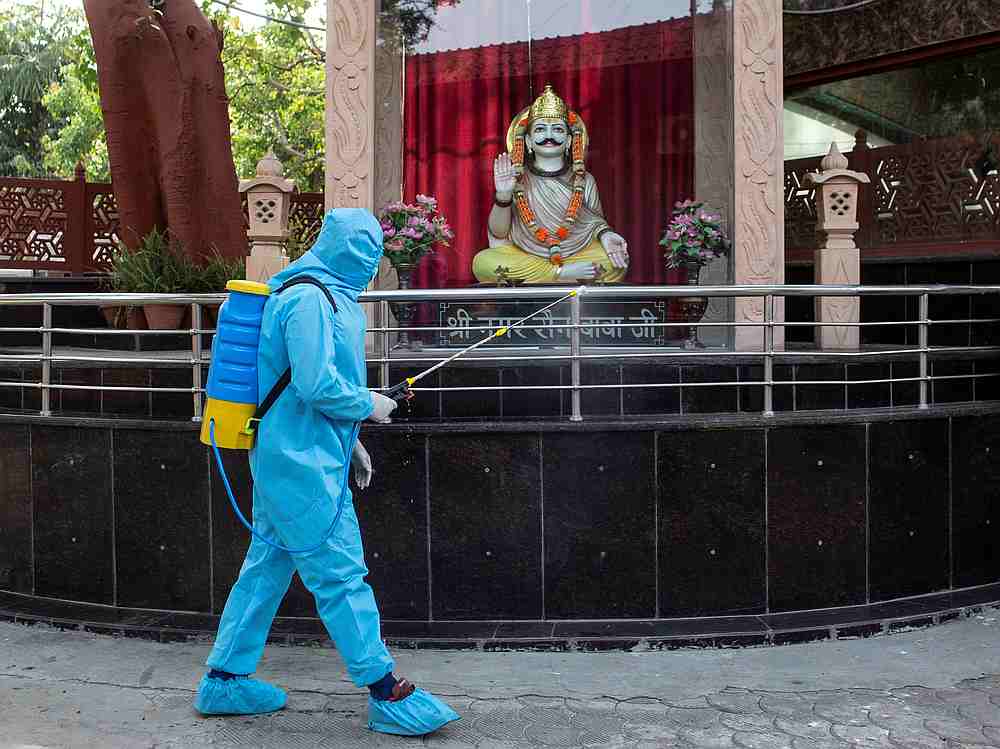 A health worker wearing protective gear sprays disinfectant at a crematorium to slow the spreading of Covid-19 in New Delhi, India April 14, 2020. u00e2u20acu201d Reuters pic