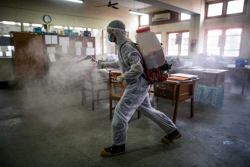 A volunteer wearing a protective suit sprays disinfectant inside a government office following the Covid-19 outbreak in Yangon, Myanmar March 31, 2020. u00e2u20acu201d Reuters pic