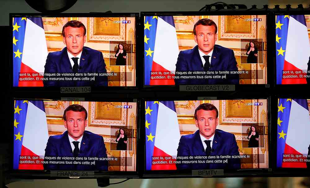 French President Emmanuel Macron addresses the nation about the coronavirus disease outbreak, on television screens in Paris, France April 13, 2020. u00e2u20acu201d Reuters pic