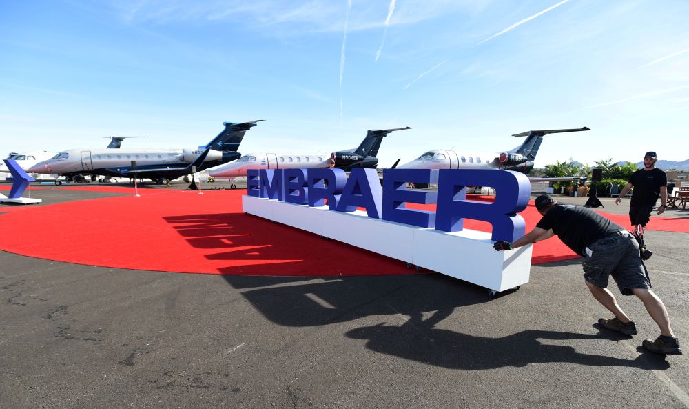 Workers set up at the Embraer booth prior to the opening of the National Business Aviation Association  exhibition in Las Vegas October 21, 2019. u00e2u20acu2022 Reuters pic