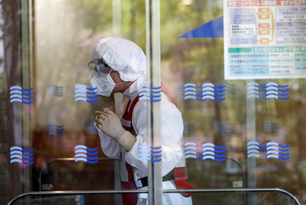 A doctor wearing an N95 mask prepares a simulation for drive-through polymerase chain reaction (PCR) tests for Covid-19 at Edogawa ward in Tokyo, Japan April 22, 2020. — Reuters pic
