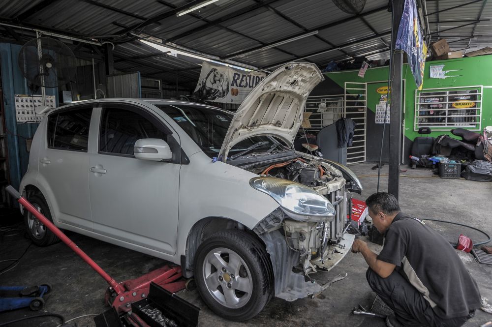A mechanic repairs a car at his workshop in Kuala Lumpur April 14, 2020. — Picture by Shafwan Zaidon