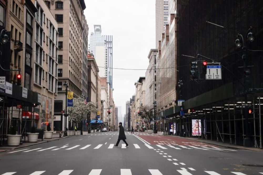 A man crosses a nearly empty 5th Avenue in midtown Manhattan during the outbreak of the coronavirus disease (Covid-19) in New York City, New York, March 25, 2020. u00e2u20acu201d Reuters pic