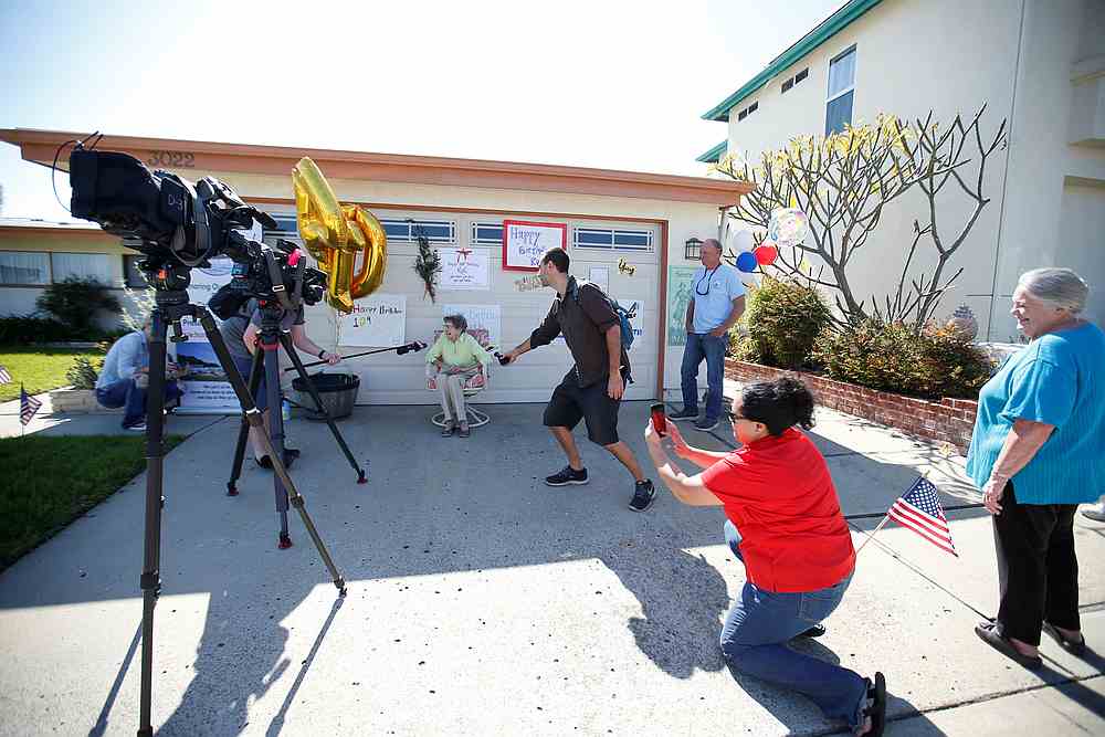 Television crew and people keep their social distance as they focus outside the home of former US Marine nurse Ruth Gallivan celebrating her 104th birthday in San Diego, California April 1, 2020. u00e2u20acu201d Reuters pic
