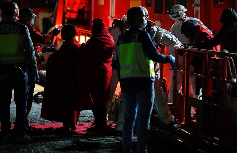 Red Cross members take temperature of migrants before disembarking from a Spanish coast guard vessel in the port of Arguineguin on the island of Gran Canaria, Spain April 4, 2020. u00e2u20acu201d Reuters pic