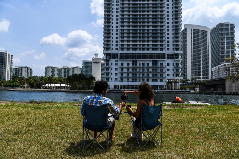 Italian chef Aldo Giaquinto (left) and his wife Vera Kozlovskaia eat their breakfast in a park near a Walmart parking lot where they are living out of their car in Miami, on April 10, 2020. u00e2u20acu201d AFP pic