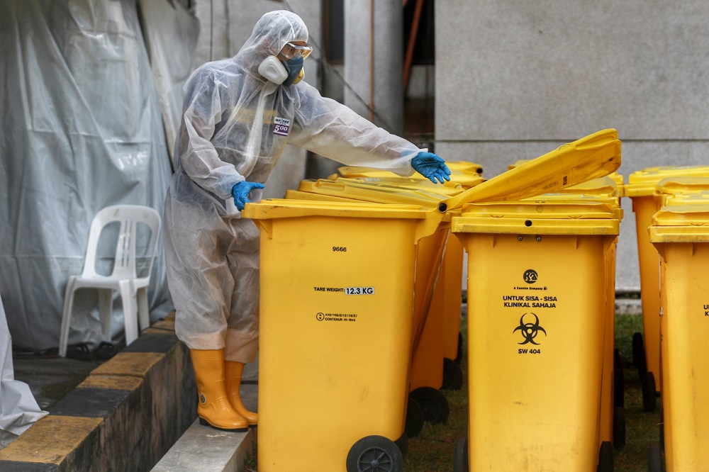 A health worker conducts checks on clinical waste during Covid-19 screening at the Gombak Land and District office April 22, 2020. u00e2u20acu2022 Picture by Ahmad Zamzahuri