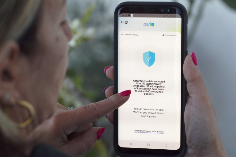 An Israeli woman checks on her phone the Hamagen (shield) application that was launched earlier this month by the health ministry, in the Israeli coastal city of Netanya. u00e2u20acu2022 AFP pic