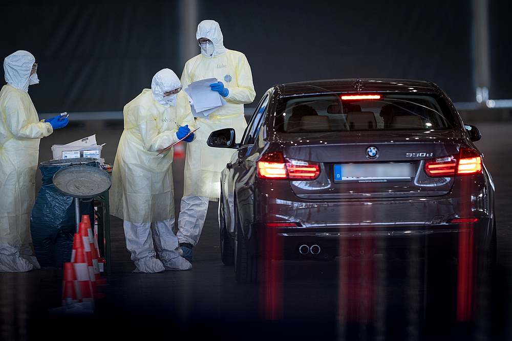 Medical workers take samples from patients at a coronavirus drive-in test centre at the fair grounds in Hanover, Germany, March 31, 2020. u00e2u20acu201d Peter Steffen/Pool pic via Reuters