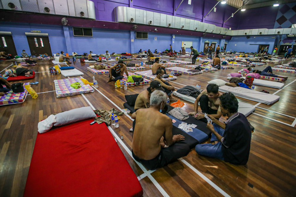 A group of men are seen playing a game of cards at the ‘Pusat Komuniti Sentul Perdana’ in Kuala Lumpur April 2, 2020. ― Picture by Hari Anggara