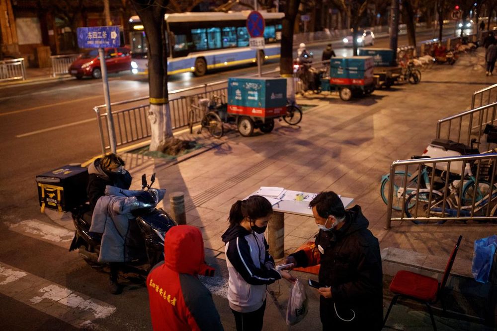 A guard checks the temperature of a woman at a checkpoint to a hutong neighbourhood in Beijing as the country is hit by an outbreak of the novel coronavirus, February 26, 2020. u00e2u20acu201d Reuters pic