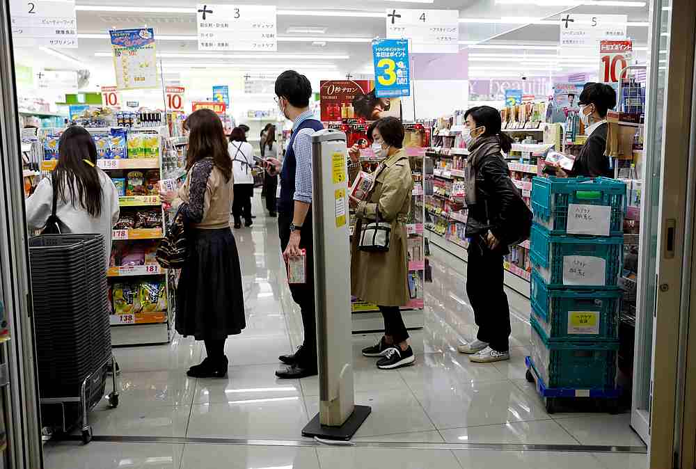 People wearing protective face masks queue to buy masks at a drugstore in Tokyo, Japan March 26, 2020. u00e2u20acu201d Reuters pic
