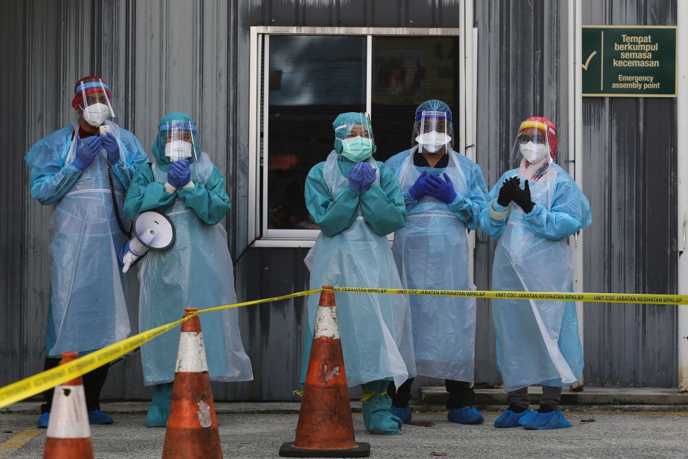 Current frontline health care staff are already stretched thin to meet the health needs of Covid-19 without the additional burden of providing vaccinations. —  Picture by Yusof Mat Isa