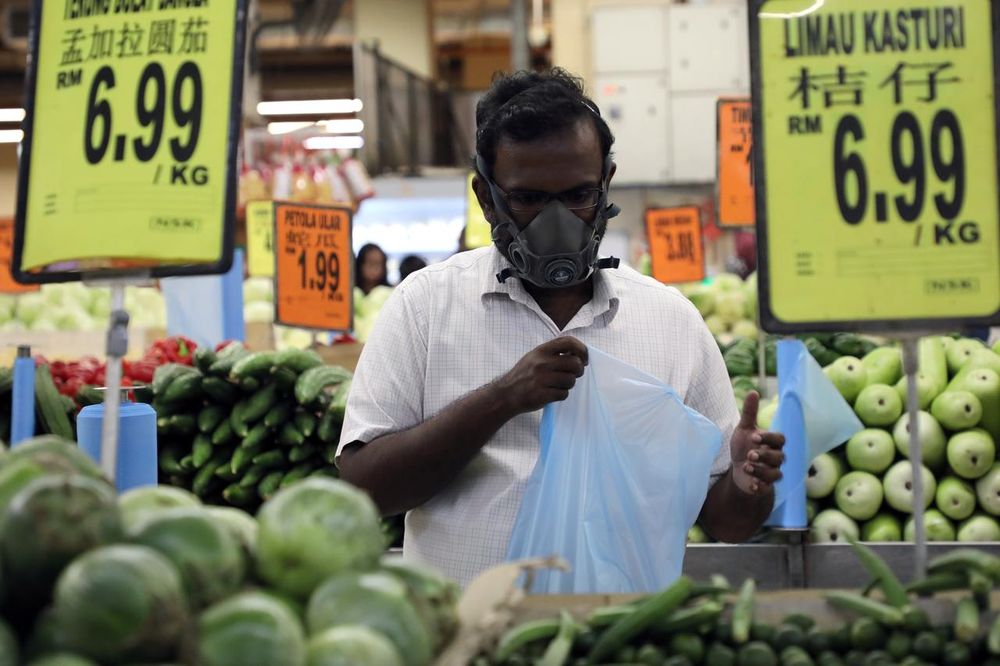 A customer wearing a protective mask, shops at a supermarket, following the outbreak of coronavirus, in Kuala Lumpur, March 15, 2020. u00e2u20acu201d Reuters pic