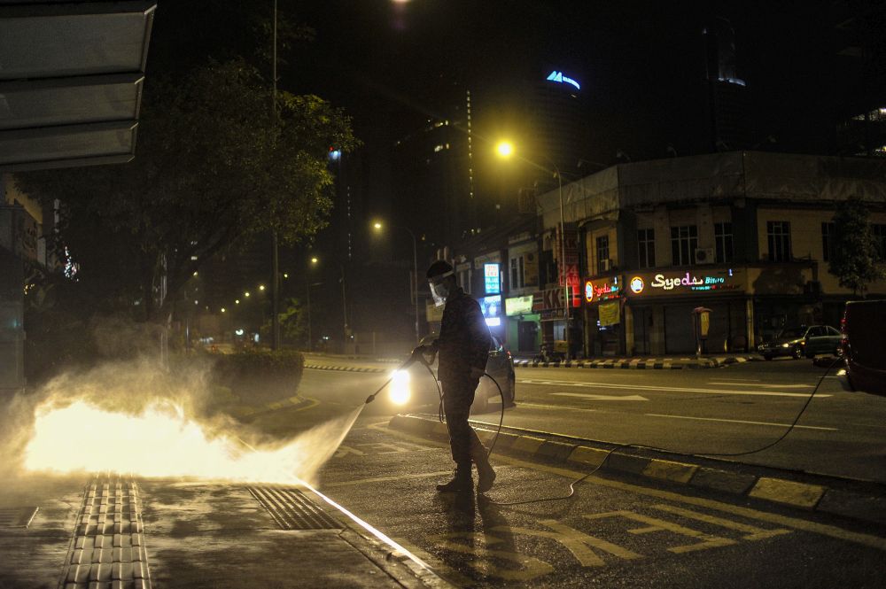 A Fire and Rescue personnel sprays disinfectant at a bus station to curb spread of Covid-19 in Kuala Lumpur March 31, 2020. u00e2u20acu201d Picture by Shafwan Zaidon