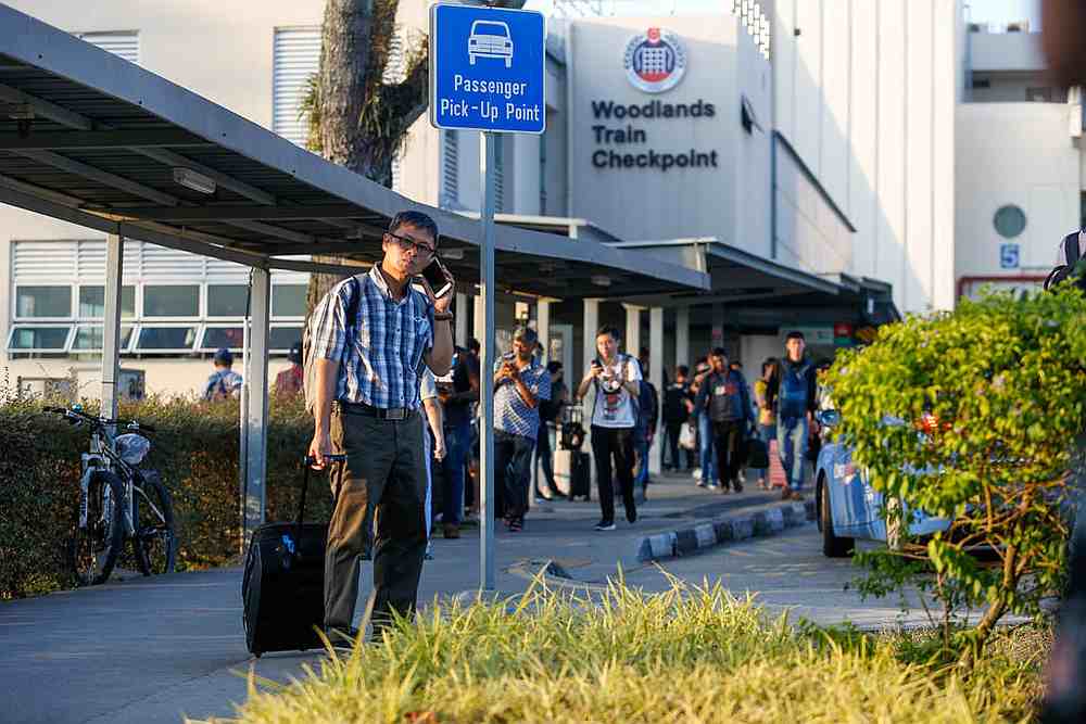 Malaysians returning home from Singapore on March 17, 2020. A number of Malaysians have remained in Singapore, but some have found themselves out of work. u00e2u20acu201d TODAY pic