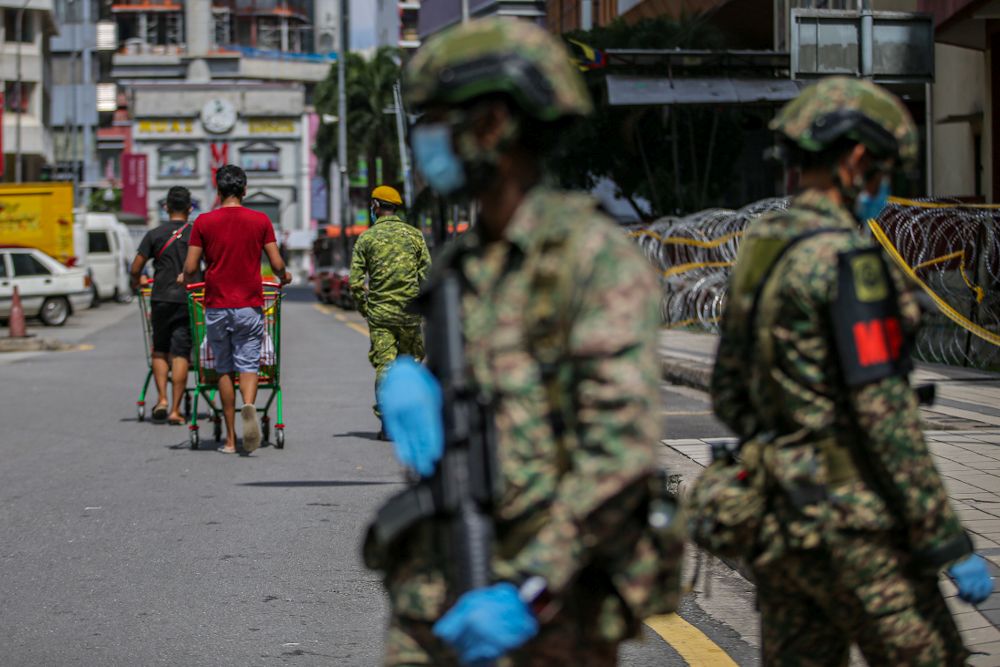People wheel shopping carts filled with groceries into Masjid India, Kuala Lumpur amid the enhanced movement control order April 15, 2020. ― Picture by Hari Anggara