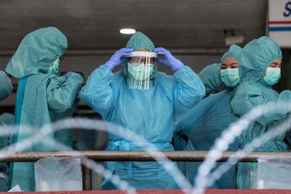 Health workers gear up before entering Menara City One in Kuala Lumpur April 16, 2020. u00e2u20acu201d Picture by Ahmad Zamzahuri 