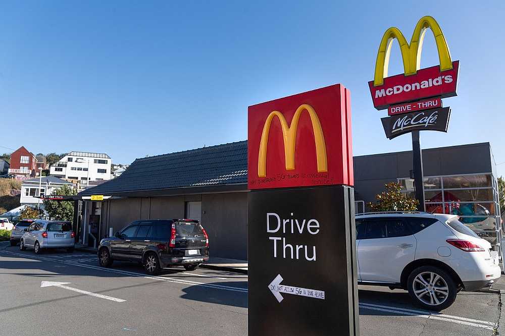 Customers queue up for the 'drive-thru' at a McDonald's restaurant on the first day of the easing of restrictions in Wellington on April 28, 2020. — AFP pic